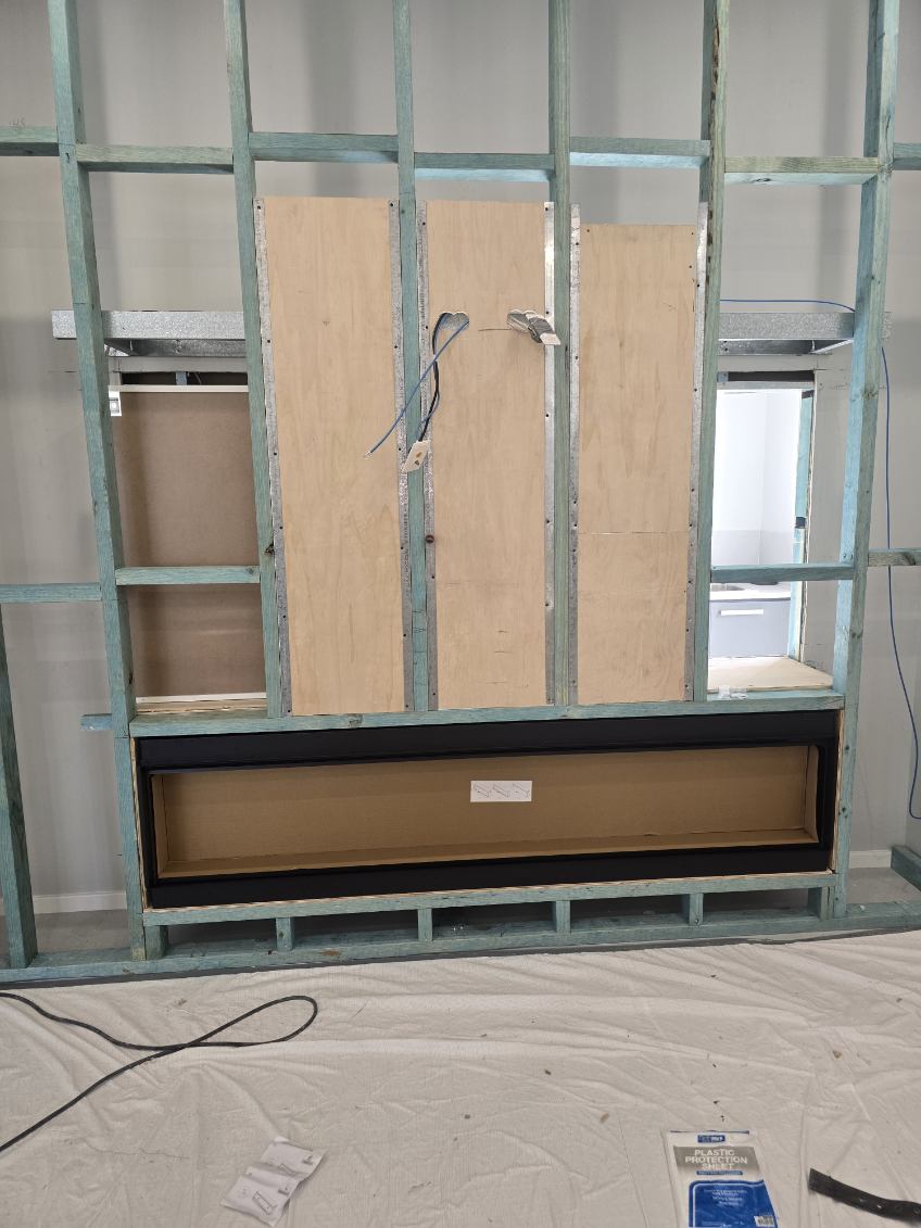 Stage 1 — steel stud framing with fireplace opening